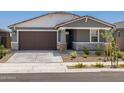 Charming single-story home featuring a two-car garage and well-maintained xeriscaped front yard at 20331 N 225Th Dr, Surprise, AZ 85387