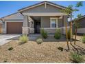 Charming single-story home featuring a two-car garage and well-maintained xeriscaped front yard at 20331 N 225Th Dr, Surprise, AZ 85387