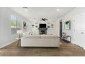 Bright living room featuring a fireplace with built-in shelving and cabinets, and modern furnishings at 2320 W Forest Pleasant Pl, Phoenix, AZ 85085