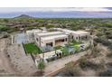 Aerial view of an estate home featuring a pool, spa, outdoor kitchen, and desert landscaping at 8386 E Leaning Rock Rd, Scottsdale, AZ 85266