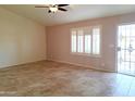Bright living room featuring tile floors and window shutters at 8203 E Nopal Ave, Mesa, AZ 85209