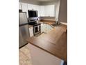 Well-equipped kitchen with stainless steel appliances, wood countertops, and ample cabinet space at 3845 E Greenway Rd # 131, Phoenix, AZ 85032