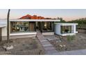 Sleek modern home featuring a minimalist design, desert landscaping, and mountain views at 6623 N Hillside Dr, Paradise Valley, AZ 85253