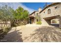 Stone house with covered entry and paved driveway at 8000 E Mariposa Grande Dr, Scottsdale, AZ 85255