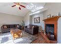 Living room with fireplace, two brown sofas, and a coffee table at 4952 E Princess Dr, Mesa, AZ 85205