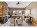 Spacious living room featuring a stone fireplace and ample natural light at 7427 E Evening Glow Dr, Scottsdale, AZ 85266