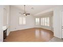 Bright living room featuring wood floors and shuttered windows at 16155 E Glenview Pl, Fountain Hills, AZ 85268