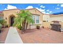 The home features a well-manicured yard and a cozy front patio with brick pavers at 13668 W Figueroa Dr, Sun City West, AZ 85375
