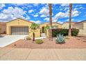 Single-Gathering home featuring a desert landscape, terracotta tile roof, and an attached garage at 13668 W Figueroa Dr, Sun City West, AZ 85375