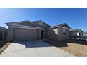 New construction home with two-car garage and desert landscaping at 2641 E Abe Truckle Ave, San Tan Valley, AZ 85140