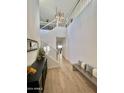 Bright entryway with high ceilings, modern chandelier, staircase and wood-look tile flooring at 6437 N 17 St, Phoenix, AZ 85016