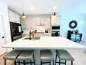 Modern kitchen featuring an island with seating, stainless steel appliances, and white cabinetry at 6437 N 17 St, Phoenix, AZ 85016