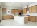 Bright kitchen featuring wooden cabinets, a white center island, and stainless steel appliances at 4799 W Flat Iron Ct, Queen Creek, AZ 85144