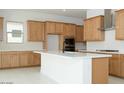 Bright kitchen featuring wooden cabinets, a white center island, and stainless steel appliances at 4799 W Flat Iron Ct, Queen Creek, AZ 85144