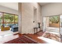 Bright entryway features stone wall, hardwood floors, and view to the living room at 6301 N 51St Pl, Paradise Valley, AZ 85253
