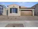 Tan house with brown garage door and landscaping at 2134 W Rowel Rd, Phoenix, AZ 85085