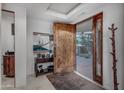 Elegant foyer featuring a solid wood door and stylish decor at 9216 E Sky Line Dr, Scottsdale, AZ 85262