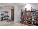 Beautiful foyer with travertine flooring, wooden shelves and stylish decor at 9216 E Sky Line Dr, Scottsdale, AZ 85262