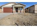 Single-story house with a brown garage door and rock accents at 16014 W Cottontail Ln, Surprise, AZ 85387