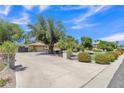 Wide driveway leading to a three-car garage, showcasing the home's ample parking and charming exterior at 4222 E Brown Rd # 31, Mesa, AZ 85205