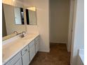 Bright bathroom with double mirrors, long vanity and tile floors at 3922 N Creosote Ct, Casa Grande, AZ 85122