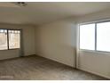A carpeted bedroom with two windows letting in natural light at 3922 N Creosote Ct, Casa Grande, AZ 85122