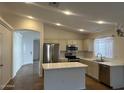 Bright kitchen featuring stainless steel appliances, an island and tile flooring at 3922 N Creosote Ct, Casa Grande, AZ 85122