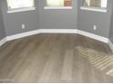 Bedroom featuring new wood floors, baseboard trim, and lots of natural light at 4512 W Stoneman Dr, Anthem, AZ 85086