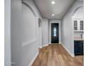 Inviting entryway with wood floors and a decorative front door, leading into the home's interior at 4512 W Stoneman Dr, Anthem, AZ 85086