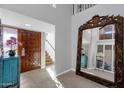 Bright and spacious entryway with a large mirror and staircase at 7401 N Scottsdale Rd # 3, Paradise Valley, AZ 85253
