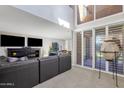 Open living area with large sectional sofa and access to backyard at 7401 N Scottsdale Rd # 3, Paradise Valley, AZ 85253