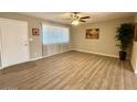 Bright living room with wood floors, a ceiling fan, and a large window at 2044 W 9Th Ave, Apache Junction, AZ 85120