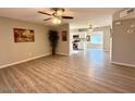 Open concept living room with wood-look floors flowing into an adjacent kitchen at 2044 W 9Th Ave, Apache Junction, AZ 85120