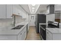 Bright kitchen featuring white cabinets, modern appliances, and stylish finishes at 10408 N 11Th St # 2, Phoenix, AZ 85020