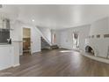 Open floor plan features vinyl flooring, staircase, and kiva fireplace at 10408 N 11Th St # 2, Phoenix, AZ 85020