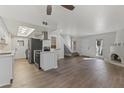 Spacious living area with modern kitchen, staircase, and a cozy kiva fireplace at 10408 N 11Th St # 2, Phoenix, AZ 85020