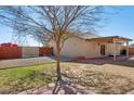 Spacious backyard with a covered patio, mature landscaping, brick accents and access to walking path at 3202 E Decatur St, Mesa, AZ 85213