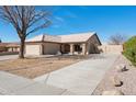 Inviting single-story home featuring a well-maintained tile roof and a spacious driveway leading to a two-car garage at 3202 E Decatur St, Mesa, AZ 85213