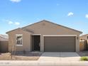 Well-maintained single-story home with a two-car garage and desert landscape at 3451 E Alexander Dr, San Tan Valley, AZ 85143