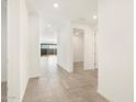 Bright hallway with tile flooring and doors to other rooms at 36933 W La Paz St, Maricopa, AZ 85138