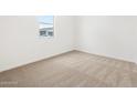 Clean, carpeted bedroom with a bright window providing natural light at 4323 W Josephine St, San Tan Valley, AZ 85144