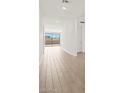 Bright hallway featuring tile flooring, recessed lighting, and sliding glass doors leading to an outdoor area at 4919 W Hunter Trl, San Tan Valley, AZ 85144