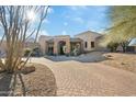 Beautiful desert home with a circular driveway and mature landscaping at 10801 E Happy Valley Rd # 27, Scottsdale, AZ 85255