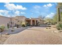 Luxury home with a stone facade and desert landscaping at 10801 E Happy Valley Rd # 27, Scottsdale, AZ 85255