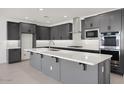 Modern kitchen with gray cabinets, a spacious island, and stainless steel appliances at 25137 N 171St Ave, Surprise, AZ 85387