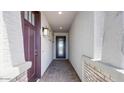 Inviting entryway with a covered porch, brick pathway, and modern front door at 25149 N 171St Ave, Surprise, AZ 85387
