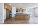Spacious kitchen featuring an island, stainless steel appliances, and wood-look tile flooring at 25149 N 171St Ave, Surprise, AZ 85387