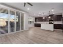 A modern kitchen features dark cabinetry, a center island with white countertops, and sliding glass door at 756 E Zion Dr # 103, Gilbert, AZ 85297
