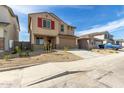 Two-story home featuring red shutters and a two car garage with desert landscaping at 8552 N 170Th Ln, Waddell, AZ 85355