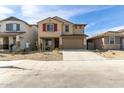 Two-story home featuring red shutters and a two car garage with desert landscaping at 8552 N 170Th Ln, Waddell, AZ 85355